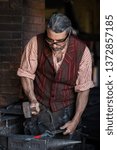 blacksmith with hammer in process