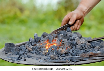 A blacksmith heating iron in a furnace on a marketplace - Powered by Shutterstock