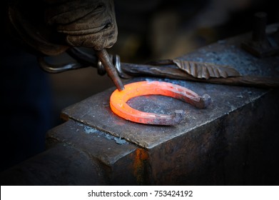 The blacksmith kicks a horseshoe close up . - Powered by Shutterstock