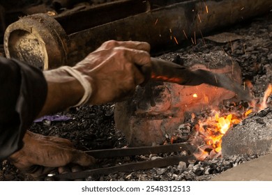 Blacksmith in Luar Baduy village heating iron to make a knife, Baduy, November 10,2024 - Powered by Shutterstock