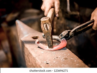 Blacksmith make a horseshoe