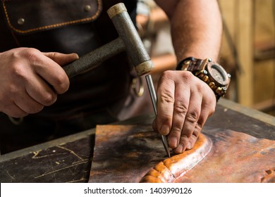 a blacksmith makes a piece of bronze