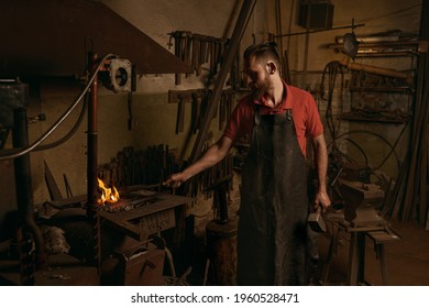 Blacksmith making flames for work in workshop