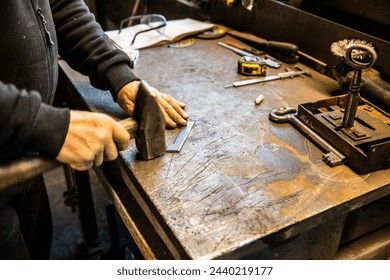 blacksmith metal workshop metal table hand hammer work - Powered by Shutterstock