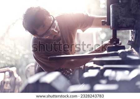 Blacksmith using vise grip in forge