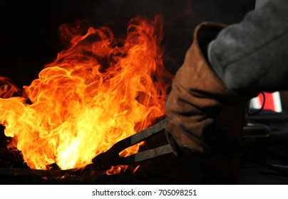 A 
blacksmith at work with glowing irons.
Hot iron forge, a blacksmith at work with red-hot iron. - Powered by Shutterstock