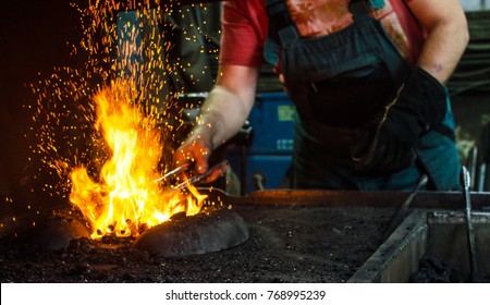 Blacksmith at work, hit with a hammer by a hot metal on the anvil. - Powered by Shutterstock