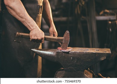 Blacksmith working on metal on anvil at forge high speed detail shot - Powered by Shutterstock