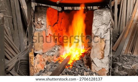 Blacksmith's forge fire heating metal rod