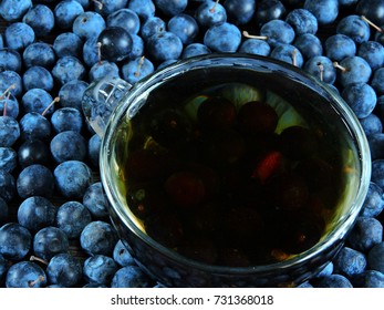 Blackthorn Berries And A Cup Of Tea. Close Up. Top View.