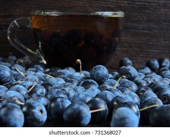 Blackthorn Berries And A Cup Of Tea. Close Up.