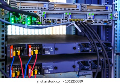 Blade panel, switch, cable, LED lamps in data center. Communication and internet network server room. Close up fiber optic wires, installed in rack