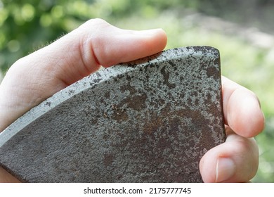 Blade sharpness check. Finger on the edge of a steel blade. - Shutterstock ID 2175777745