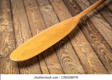 Blade Of Wooden Canoe Paddle (beaver Tail) Against Weathered Wood Background