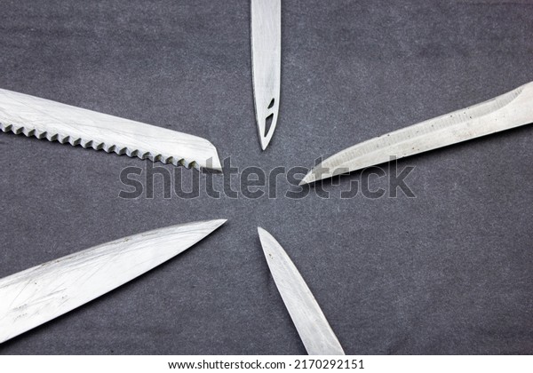 The Blades of knives\
concept. Sharp steel blades of knives on a dark background. Sharp\
knives collection.