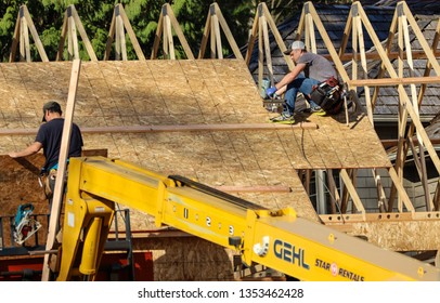 Blaine, WA / US - 03/29/2019: Workers Complete Sheeting On The Roof Of A New Home Being Constructed In The Semiahmoo Resort Community Of Blaine, A Sign Of Strong Housing Market There.