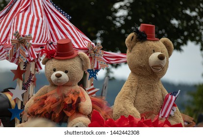 Blaine, WA / USA – July 4, 2019: Old fashioned Fourth of July Parade and Celebration. Two giant Teddy Bears decked out in patriotic dress ride a float in the parade