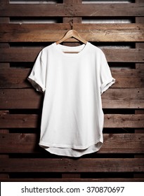 Blanc White Tshirt Hanging On Wood Background