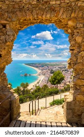 Blanes Beach Through A Stone Door Of St. John Castle. Aerial Panoramic View In Costa Brava In A Beautiful Summer Day, Spain