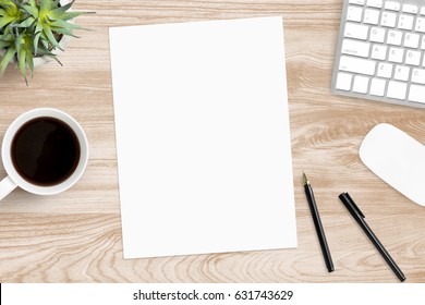 Blank A4 Paper Is In The Middle Of Wood Office Desk Table With Supplies. Top View With Copy Space, Flat Lay.