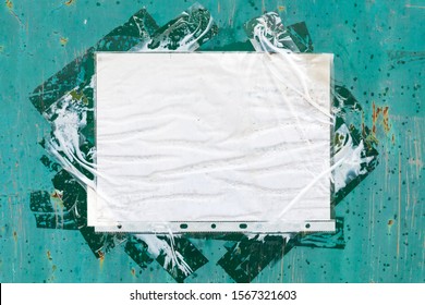 Blank Ad Form, A Paper Sheet In A Punched Pocket Taped To Grungy Green Metal Wall