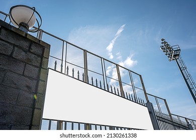 Blank Advertise White Vinyl Banner Fixed On Iron Fence Of Urban Stadium. Announcement And Business Concept.