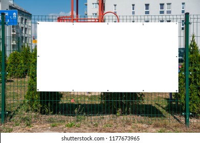 Blank Advertising Banner Mounted On The Fence. 