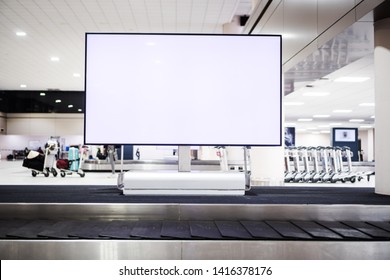Blank advertising billboard at conveyor belt luggage in airport at airport. Copy space for customer text information advertise about tourism transport business etc.