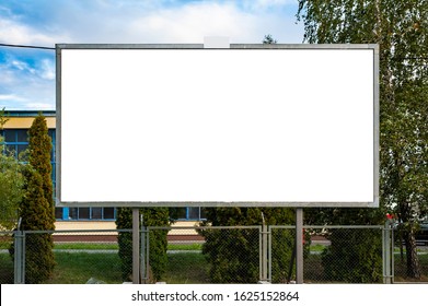 Blank advertising billboard mockup in front of industrial building - Shutterstock ID 1625152864