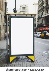 Blank Advertising Light Box On Bus Stop, Mockup Of Empty Ad Billboard On Night Bus Station, Template Banner On Background City Street For Text In Barcelona, Afisha Board And Headlights Of Taxi Cars