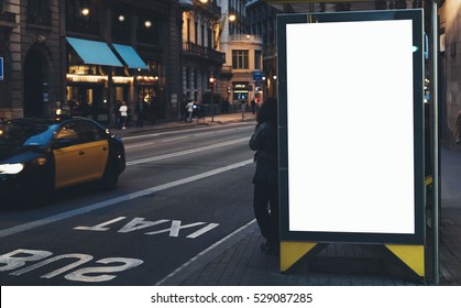 Blank Advertising Light Box On Bus Stop, Mockup Of Empty Ad Billboard On Night Bus Station, Template Banner On Background City Street For Text In Barcelona, Afisha Board And Headlights Of Taxi Cars