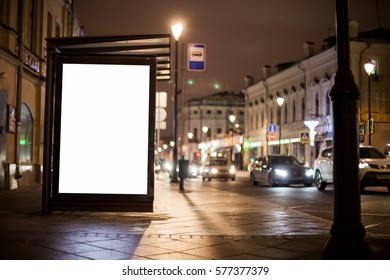 Blank Advertising Light Box On Bus Stop, Mockup Of Empty Ad Billboard On Night Bus Station, Template Banner On Background City Street For Text, Afisha Board And Headlights Of Cars.