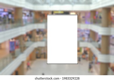 Blank Advertising Poster Banner Mockup In Modern Retail Environment; Vertical Hanging Billboard In Shopping Mall, Out-of-home OOH Media Display Space; Blur Background