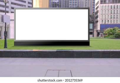 Blank Advertising Poster Banner Mockup In Open Air Environment, Buildings In Background; Large Digital Lightbox Display Screen. Billboard, Poster, Out-of-home OOH Media Display Space, On Green Field