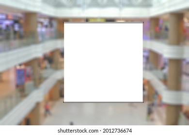 Blank Advertising Poster Banner Mockup In Modern Retail Environment; Square Hanging Billboard In Shopping Mall, Out-of-home OOH Media Display Space; Blur Background