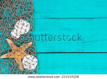 Blank antique teal blue aged wooden sign background with fish net border, sand dollars and one golden starfish