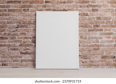 Blank art canvas leaning against the brick wall. Clean surface for mockup, art presentation