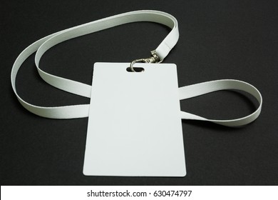 Blank Badge Mockup Isolated On Black. Plain Empty Name Tag Mock Up Hanging On Neck With String.