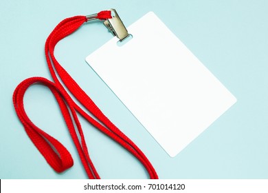 Blank Badge Mockup Isolated On Blue. Plain Empty Name Tag With Red String.