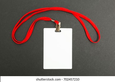 Blank Badge Mockup Isolated On Black. Plain Empty Name Tag Mock Up With Red String.