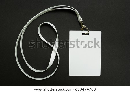 Blank badge mockup isolated on black. Plain empty name tag mock up hanging on neck with string, on white background.
