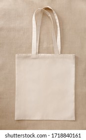 Blank beige mockup linen cotton tote bag on linen fabric. Eco nature friendly style. Environmental conservation recycling concept. - Shutterstock ID 1718840161