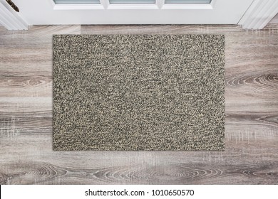 Blank Beige Woolen Doormat Before The White Door In The Hall. Mat On Wooden Floor, Product Mockup