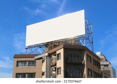 Blank Billboard Ad. Empty White Advertisement With Copy Space Atop A Generic Building In Tokyo, Japan.