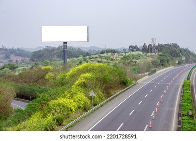 A Blank Billboard With Copy Space On A Field Near A Highway