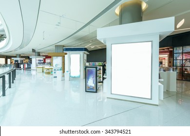 Blank Billboard In Hallway Of Modern Shopping Mall