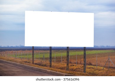 Blank billboard hoarding by the roadway, copy space for graphic design mock up, retro toned image. - Shutterstock ID 375616396