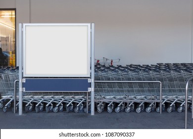 Blank billboard mock up in a supermarket, in front of shopping carts