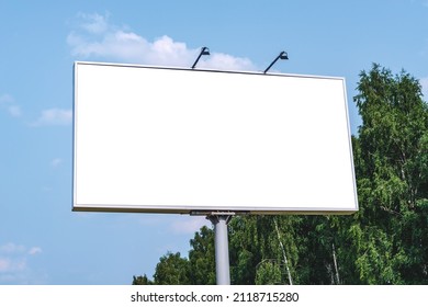 Blank billboard mockup with white screen. Against the backdrop of nature and blue sky. Business concept. Copy space banner for advertising