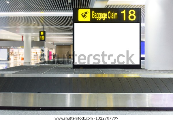 Blank billboard on Baggage\
claim area in the airport,Empty Baggage conveyor belt at the\
airport